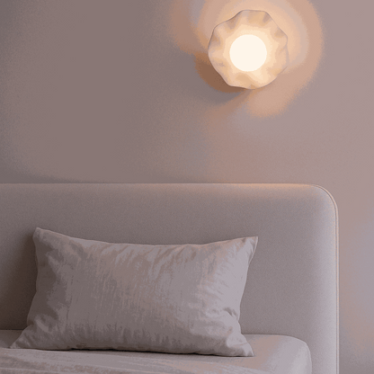 Modern battery operated wall light with textured ripple design and soft warm LED glow